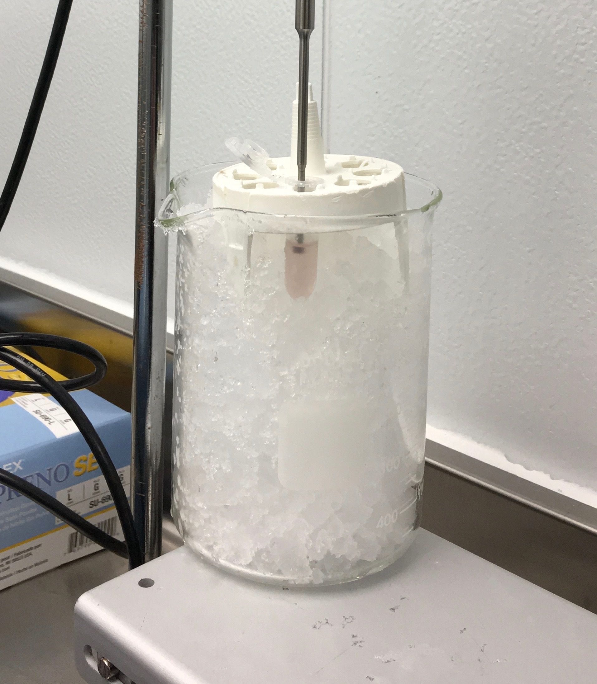 Chemical reaction in ice bath using rotary evaporator; cooling and condensation setup.